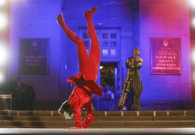 The actor in a theatrical costume is walking on the podium