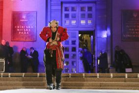 Actor in a theatrical costume on the podium
