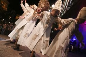 Actresses in theatrical costumes on the podium