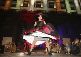 An actress in a theatrical costume on the podium