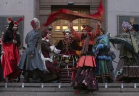 Actors in theatrical costumes on the podium