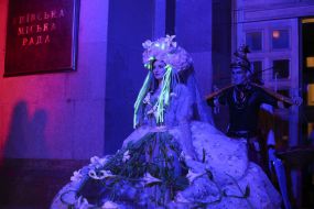 An actress in a theatrical costume on the podium