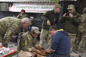 A military officer makes a clay product