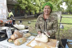 Volunteer makes a dough for dumplings