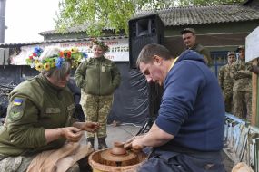 Girl-soldier makes a clay product