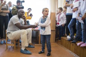 Evander Holyfield communicates with the boy