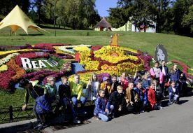 Children have a rest at the flowerbeds