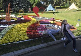 Children play around the flowerbeds
