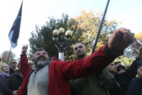 A participant in the "action on the decommissioning of Soviet idols" throws an egg