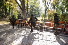 Law enforcers carry a ladder