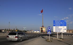Flag of Kyrgyzstan on the flagpole near the traffic junction