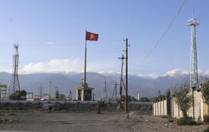 Flag of Kyrgyzstan on the flagpole near the traffic junction