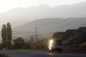 The car is on the road near the Alatau ridge