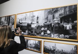The girl picks up photographs of the historic days of the Revolution of Dignity