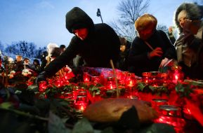 Люди ставят зажженые лампады