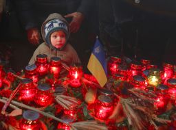 Little boy near the lit lamp