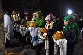 Participants of the procession hold lighted candles