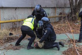 Police detain one of the participants of the fight