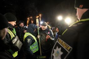 Police and participants of the torch-fire procession