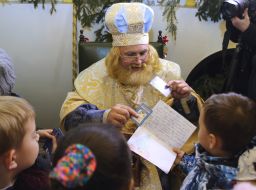 The boy gives St. Nicholas a letter