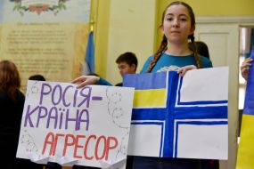 A student holds posters