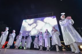 Children in angel costumes on stage