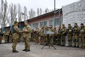Petro Poroshenko handing the trophy to the soldier