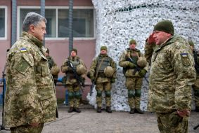 Petro Poroshenko handing the trophy to the soldier