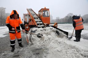 Municipal workers clean the snow