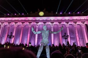 A light puppet on the background of a highlight of the building of the Odessa City Council