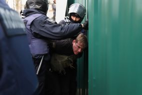 Police detain a participant