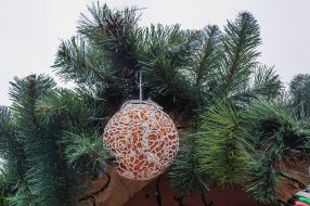 New Year's toy on a branch of a fir tree
