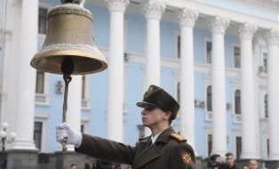 A serviceman rings in the bell of memory