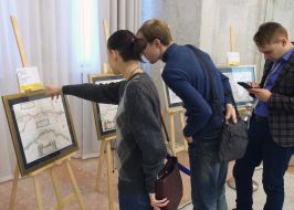 Visitor of the exhibition is studying a copy of the old map of Ukraine