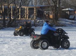 People ride quad bikes