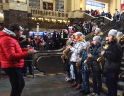 Participants of the Great Choral Fleshmobile play saxophones