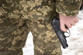 A serviceman holds Makarov's gun