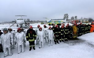 Training participants on fire suppression on an aircraft
