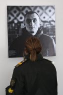 Cadet of the Academy of the State Penitentiary Service of Ukraine near photo portrait