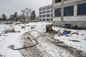 The builder works in the yard of the school number 42