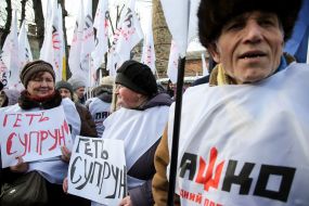 Participants of the action against Ulyana Suprun hold posters