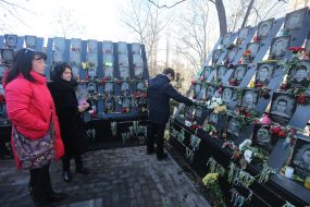 People near the photos of Heroes of Heavenly Hundreds