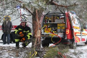 Rescuers try to unlock people from an inverted car