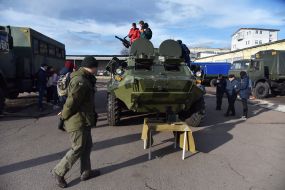 Students consider an armored car