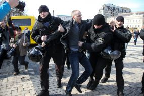 Police detain a man
