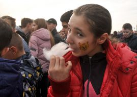 The girl eats sweet wool