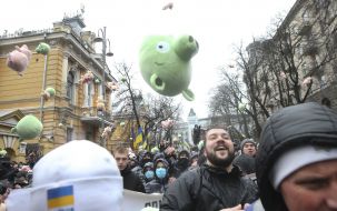 Protesters threw law enforcement officers with toy pigs.