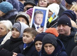 A woman holds a portrait of Petro Poroshenko