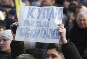 A man holds a poster