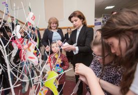 Marina Poroshenko hangs a sock on a symbolic tree